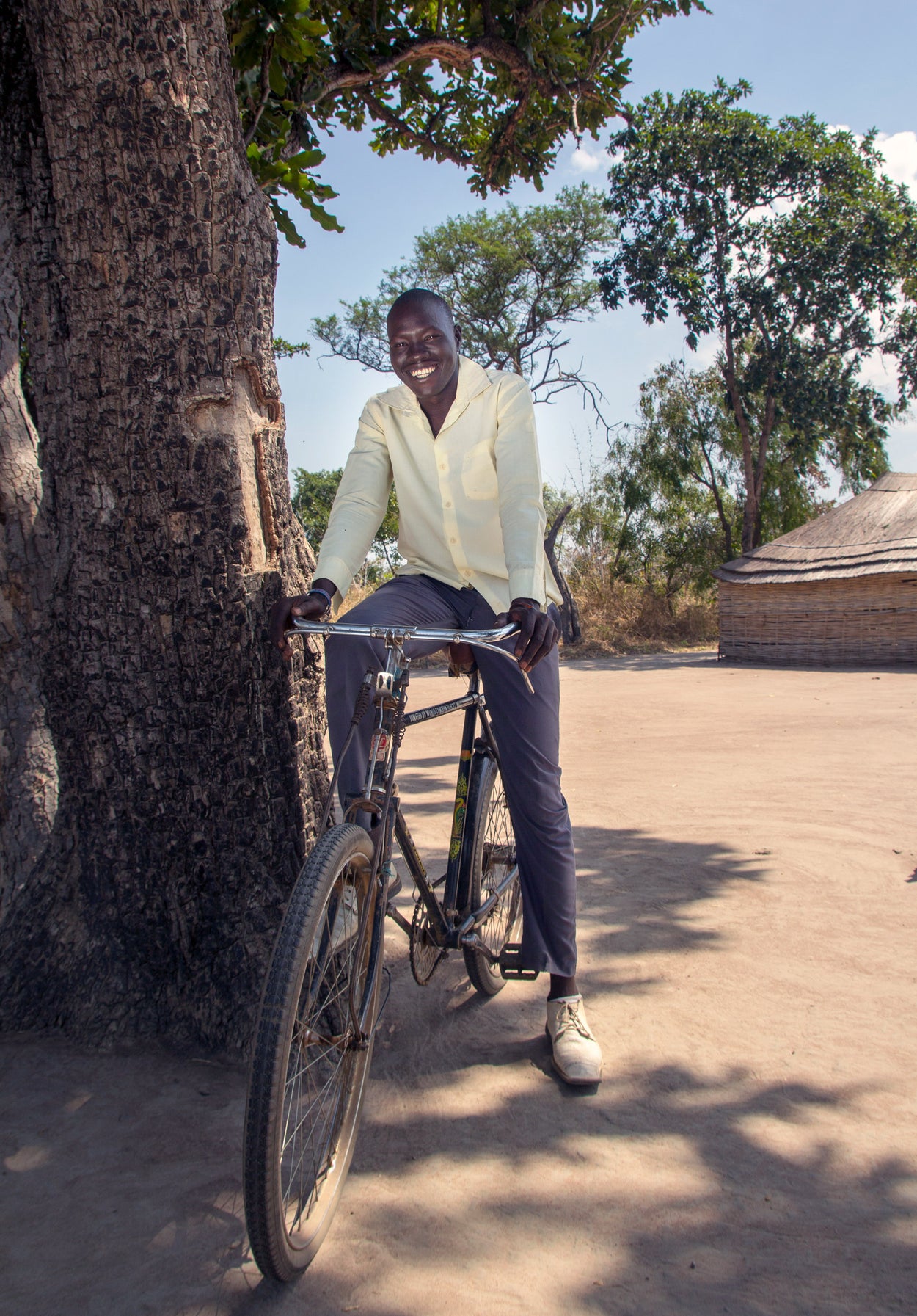 Christopher sits on his bike which allows him to go out and preach in his community.
