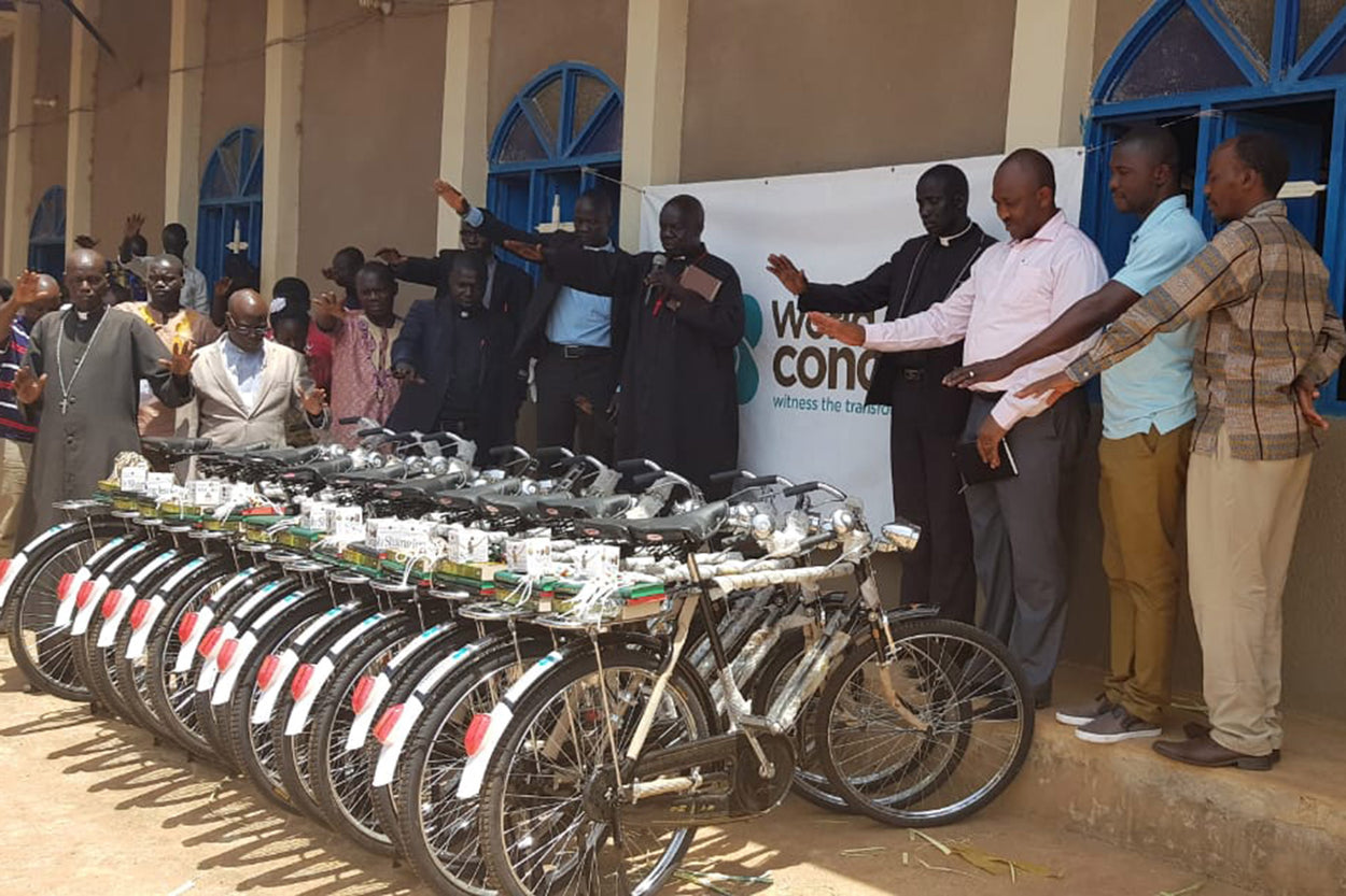 Evangelists pray over bicycles to help them spread the Good News